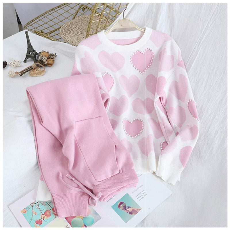 Heart-shaped beaded sportswear pullover knit set with geometric pink hearts and casual pencil pants.