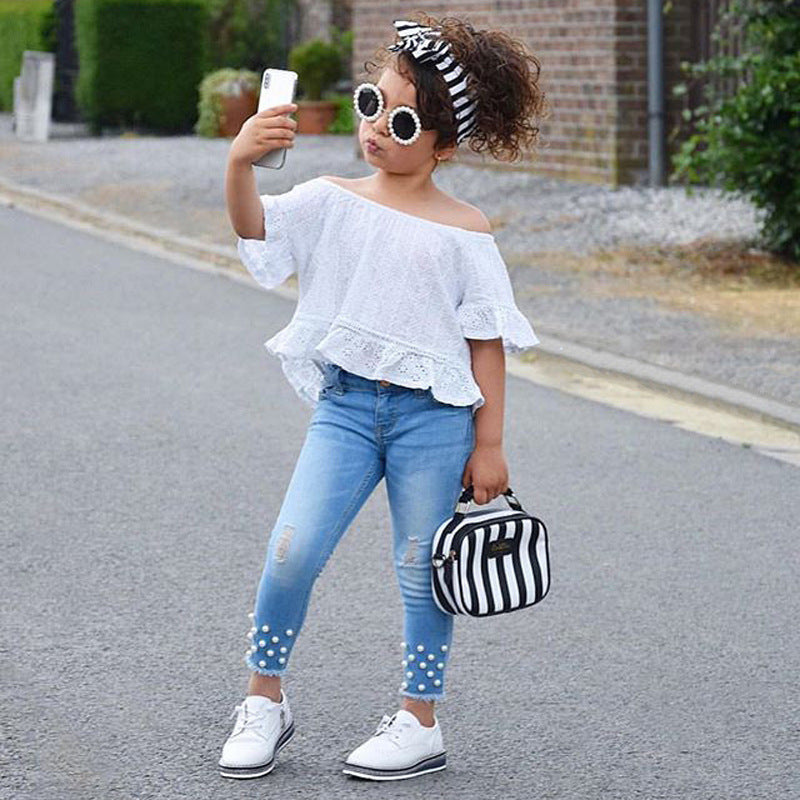 Girls wearing cute casual white shirt with pearl jean bottoms, suitable for ages 2T to 6.