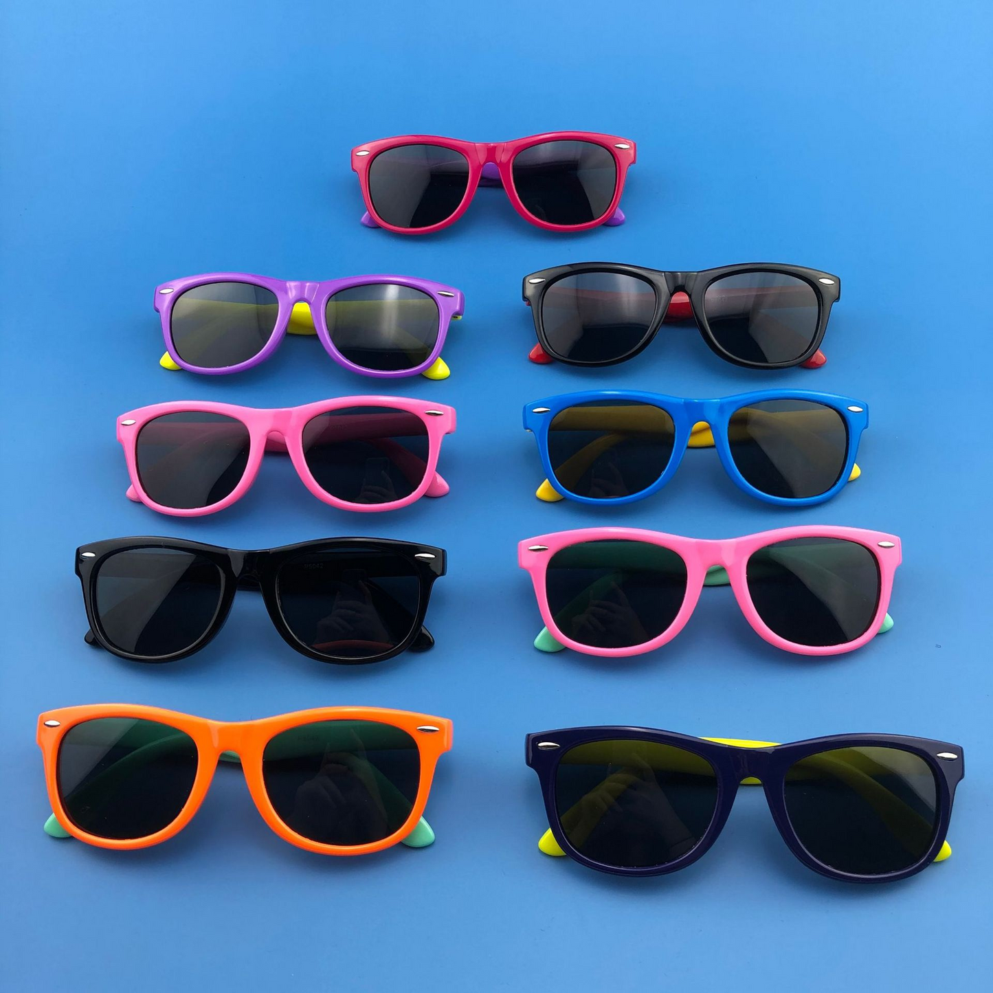 Colorful kids polarized sunglasses for ages 3-12 on blue background.