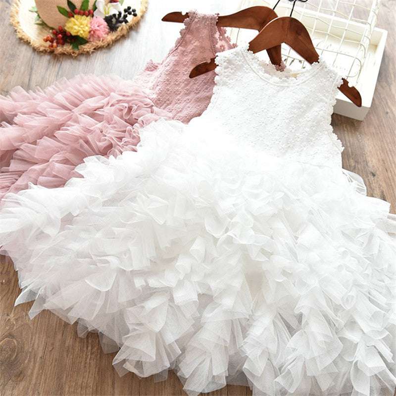 White and pink puff sleeveless dresses with ruffled layers on hangers.