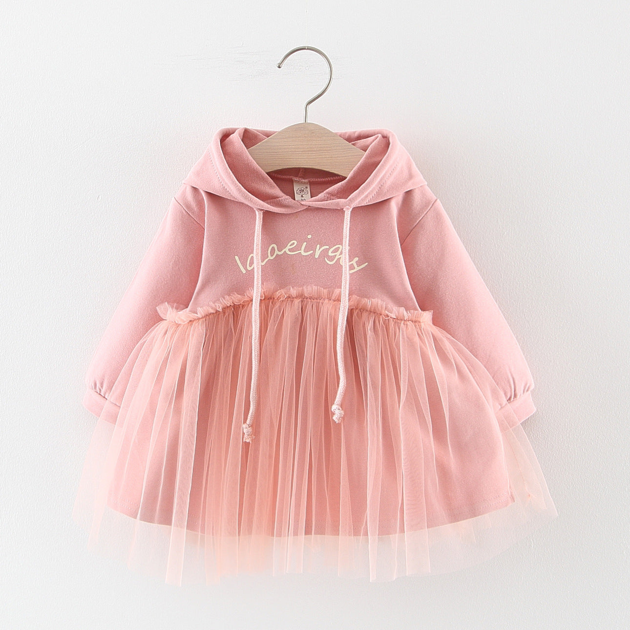 Infant pink pullover with tutu skirt on hanger.