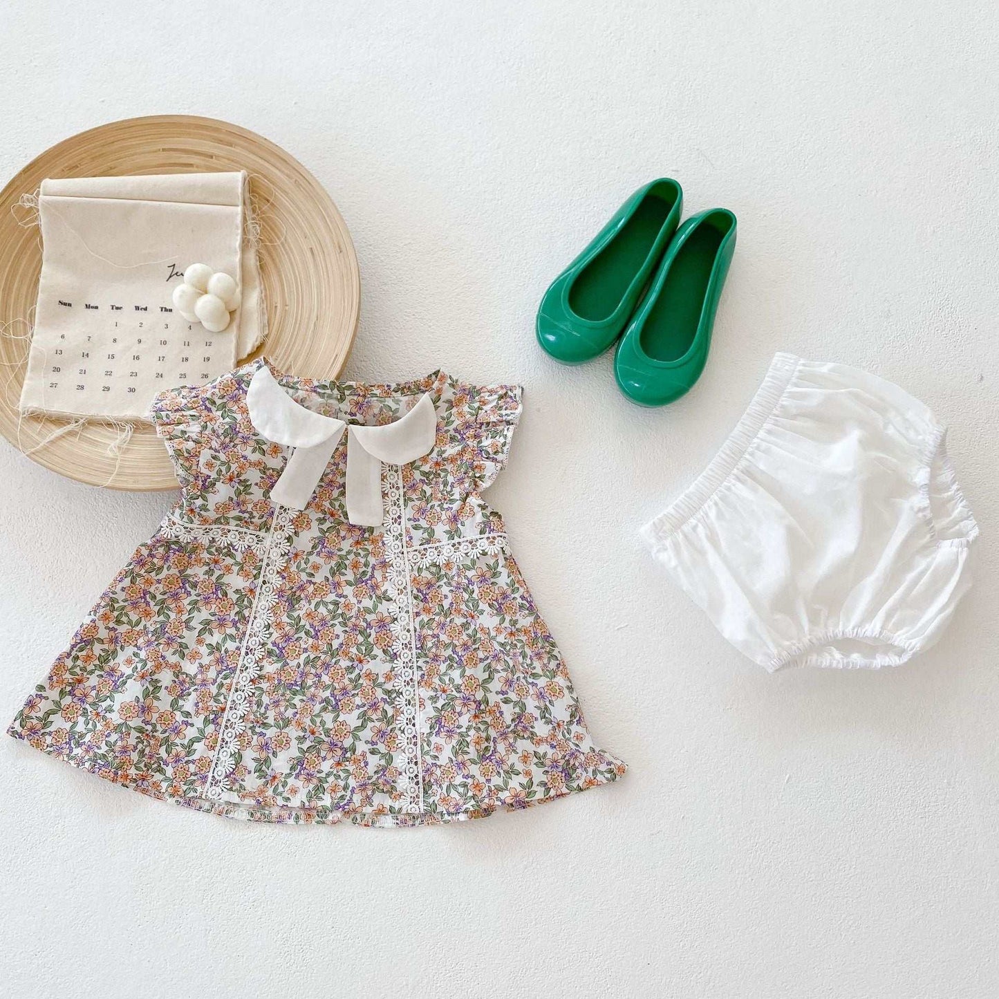 Girls floral tops with white bloomers 2pc set for infants, featuring a sleeveless floral pattern and off-white shorts, perfect for summer.