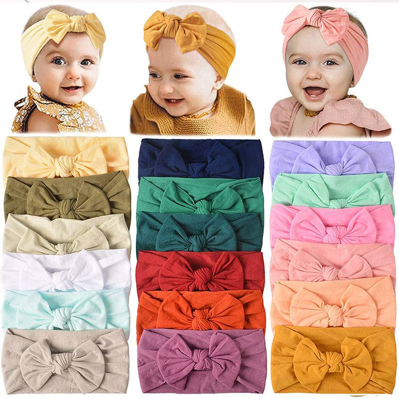 Colorful nylon baby hair bows in various shades, designed for children, featuring a floral style and plain pattern.
