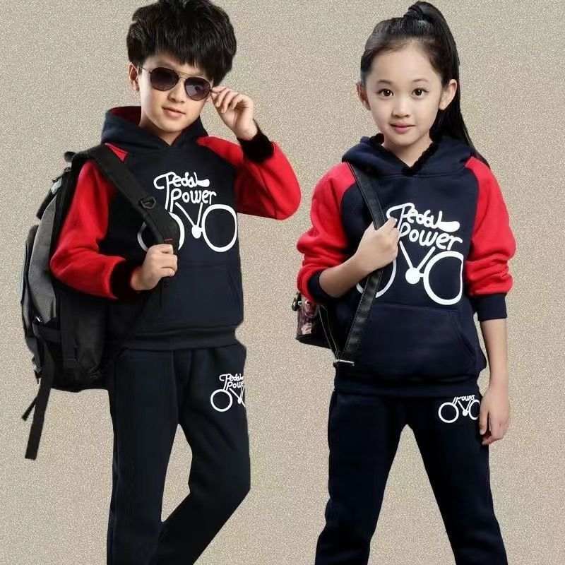 Kids in Pedal Power sports suits with bike print, long sleeves, red and navy Korean style.