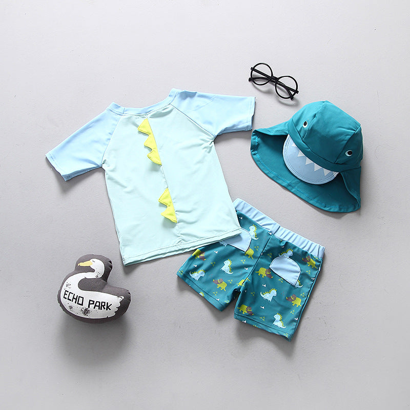 boys swimwear set with dinosaur print, light green top, matching swim trunks, and sun hat