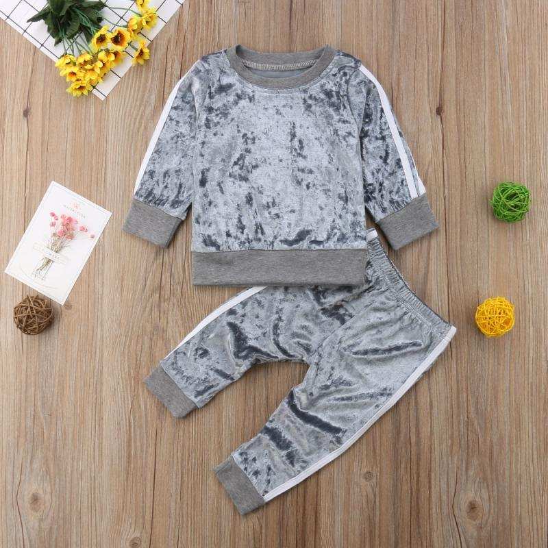 Candy-colored long sleeve 2-piece jogging set for kids on wooden floor.