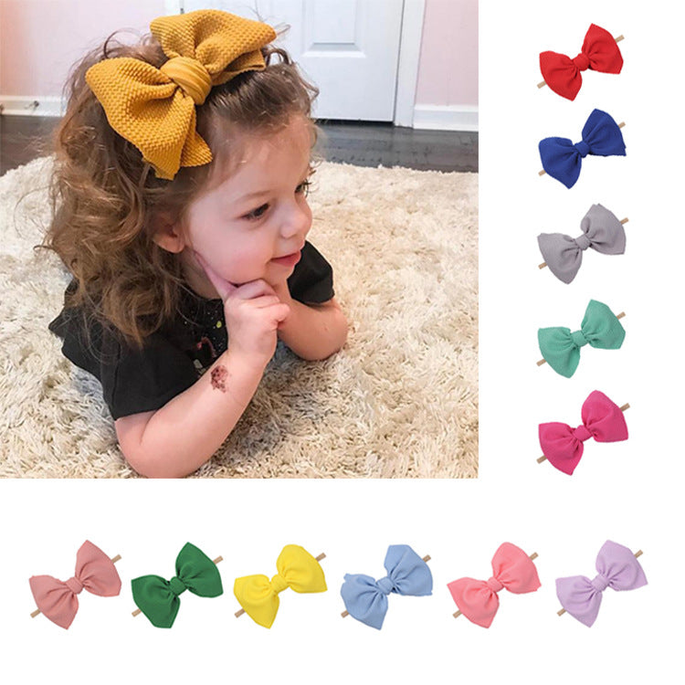 Children's bow hair accessories in waffle fabric, featuring colorful bowknots for kids.