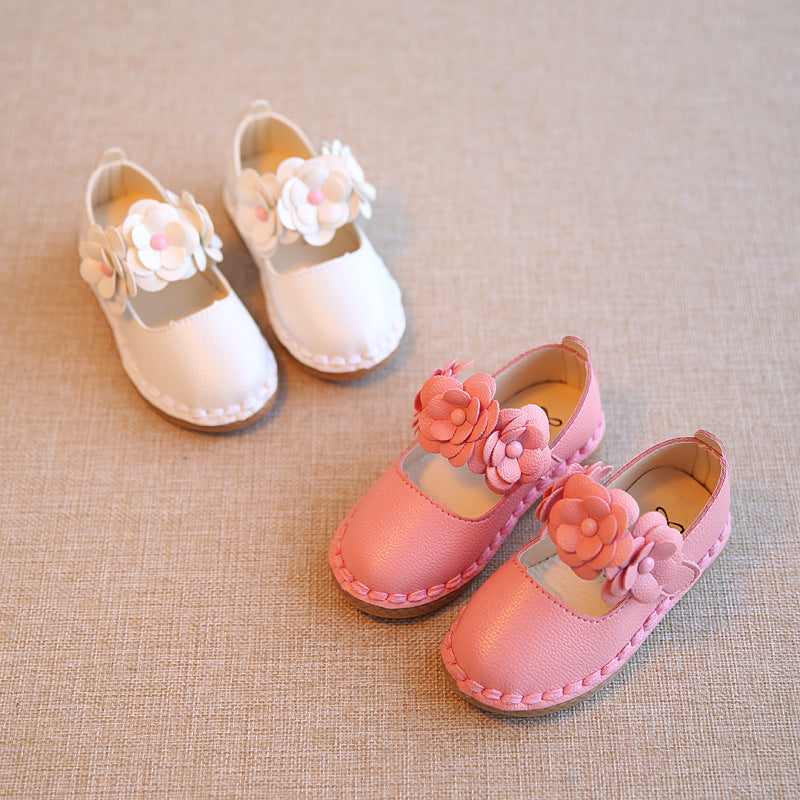 Girls casual flower strap flat shoes in pink and white colors on display.