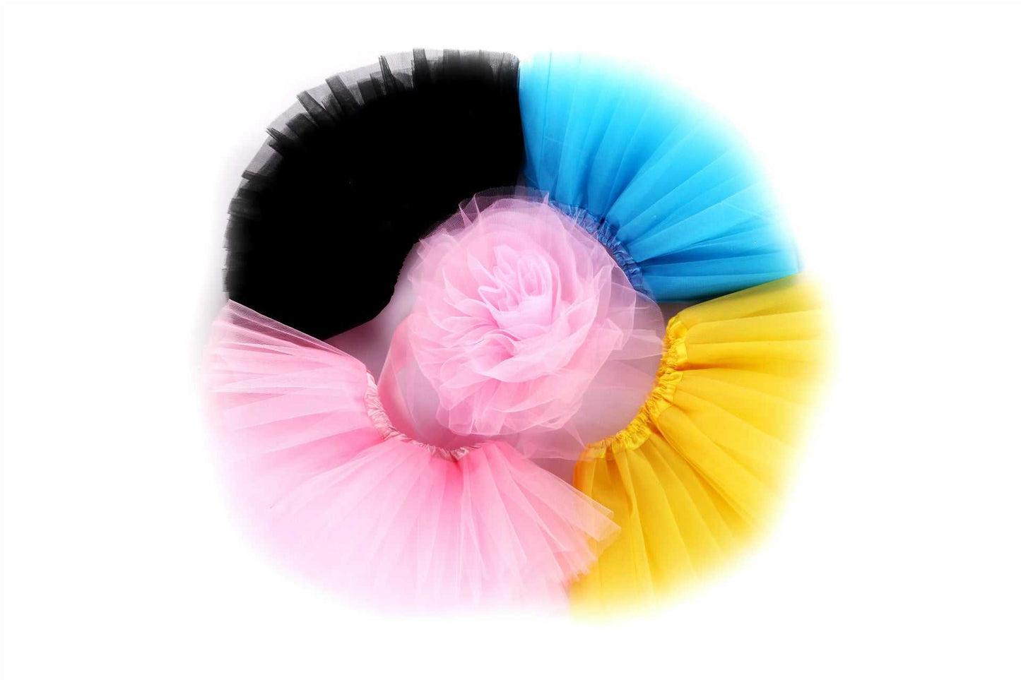 Multicolored baby half skirt ballet tutus arranged in a circle.
