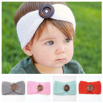 Hand-woven baby wool headband with button detail, available in multiple colors.