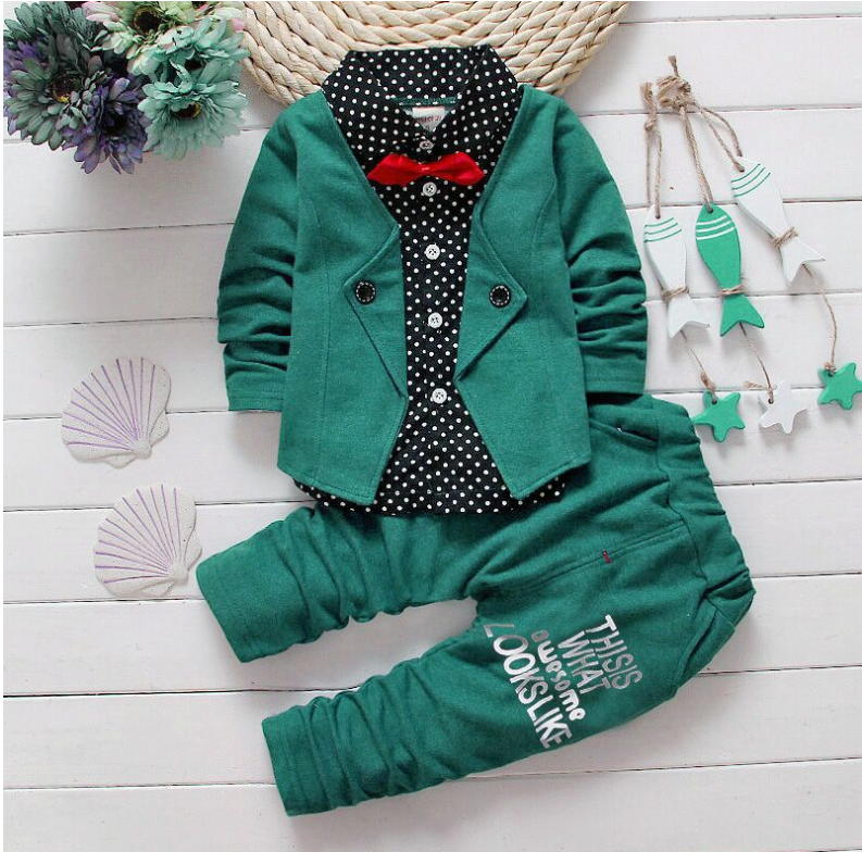 Casual kids sport suit with green jacket, polka dot shirt, and pants featuring text design.