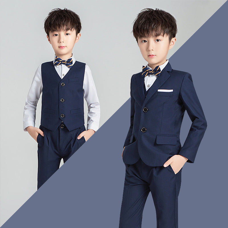 Boys solid color suit with tie in navy blue, suitable for ages 3-8, featuring a V-neck, long sleeves, and viscose fabric.