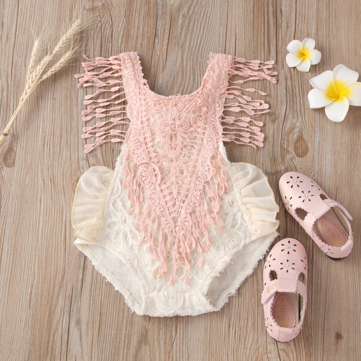 Comfortable short lace pattern baby triangle jumpsuit with pink lace detailing, sleeveless design, and polyester fabric, displayed with matching accessories.