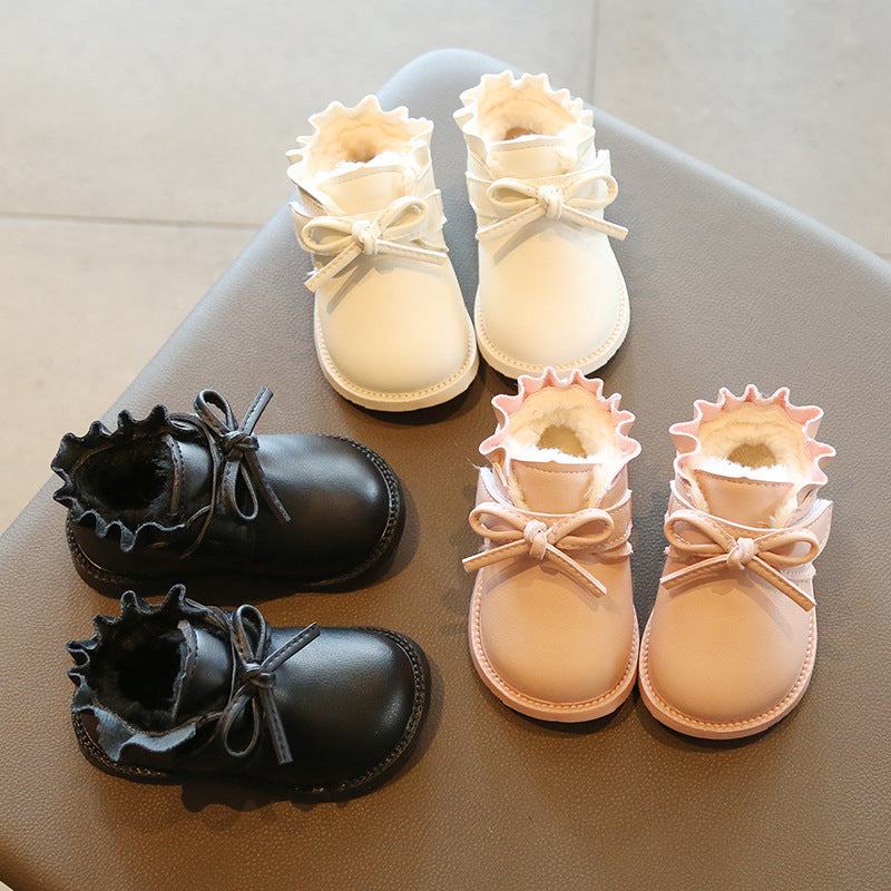Girls toddlers low fur inside boots with soft soles in black and pink.