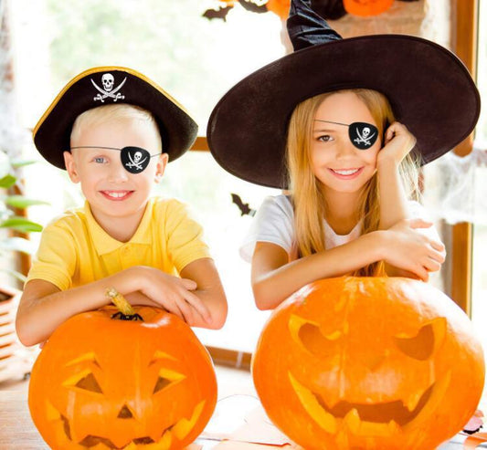 Halloween Pirate Captain costume accessories with hats and eye patches, worn by children carving pumpkins.