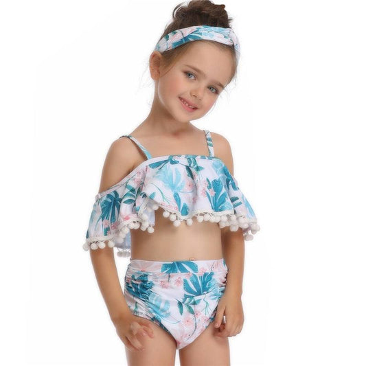 Toddler wearing a floral casual 2-piece swimsuit with shoulder ruffles and matching headband.