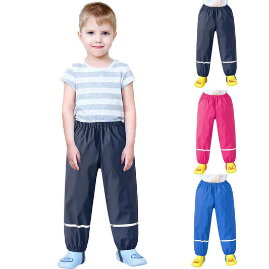 Kids wearing colorful waterproof rain pants in navy, pink, and blue; ideal for outdoor play.