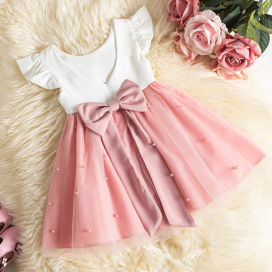 Toddler baby girls lace dress with bow and pearls, pink and white design on a soft fabric background.