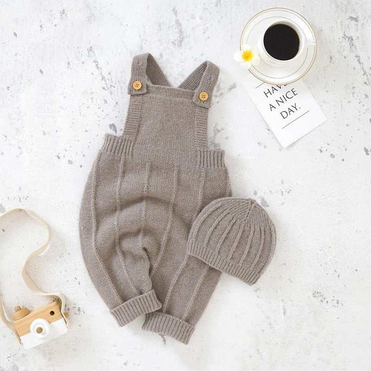 Baby's sweater full moon bodysuit with suspender and hat in dark khaki color on a textured background.